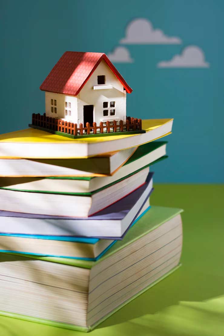 Una casa encima de unos libros que te indican tu lector personal te va a casa